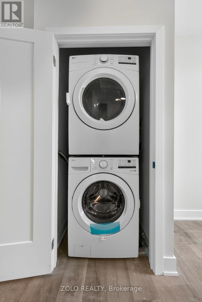 A white washing machine and dryer in a small space.