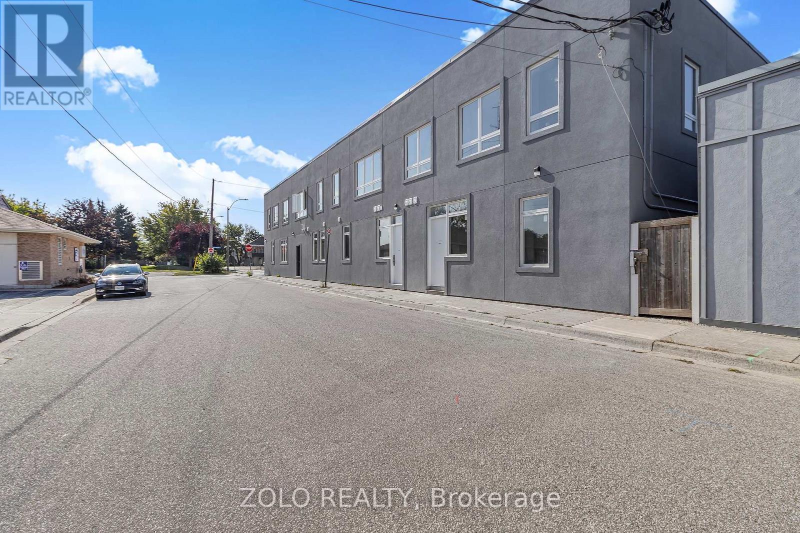A street view of a building with the text "ZOLO REALTY, Brokerage" on the bottom.