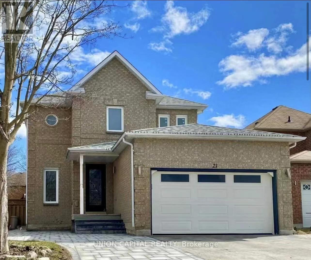 A two-story house with a garage is for sale.