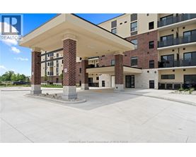 A large building with a covered walkway in front.