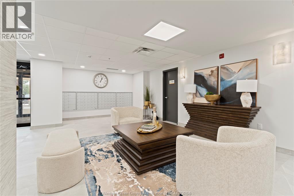 A modern office lobby with a wooden coffee table and two white chairs.