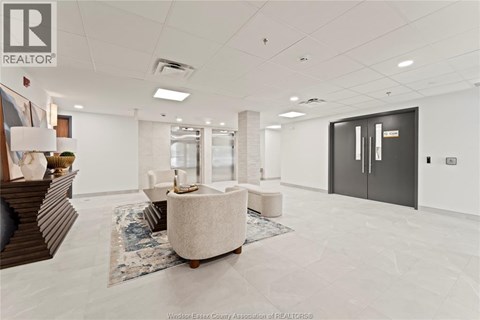 A spacious office room with a large table and chairs.
