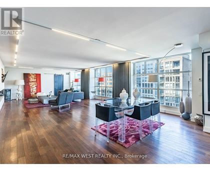 A spacious living room with a dining table and chairs.