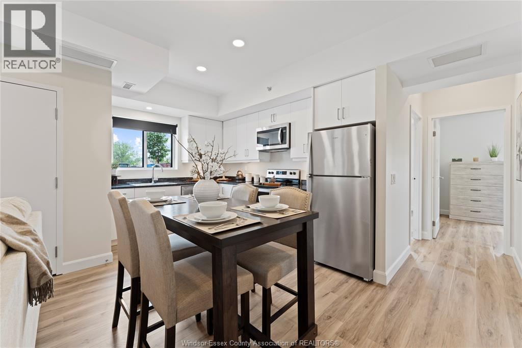 A modern kitchen with a dining table set for two.
