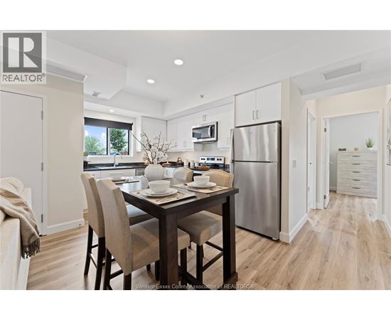 A modern kitchen with a dining table set for two.