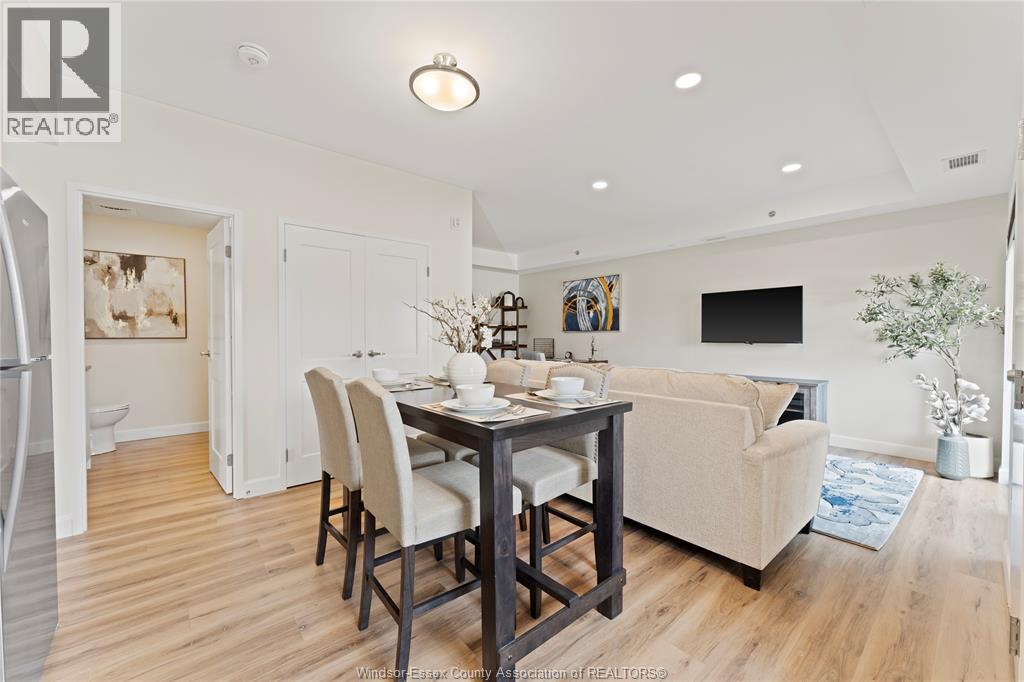 A dining room with a table set for four.