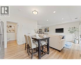 A dining room with a table set for four.