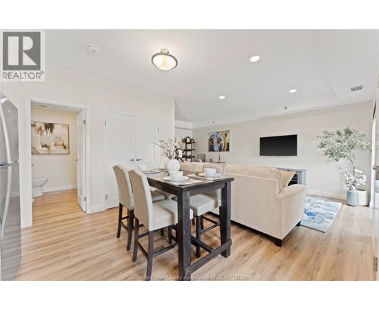 A dining room with a table set for four.