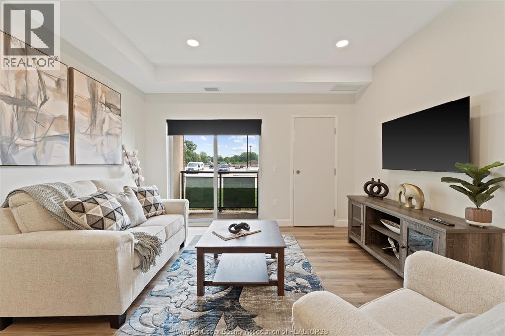 A living room with a couch, a coffee table, and a television.