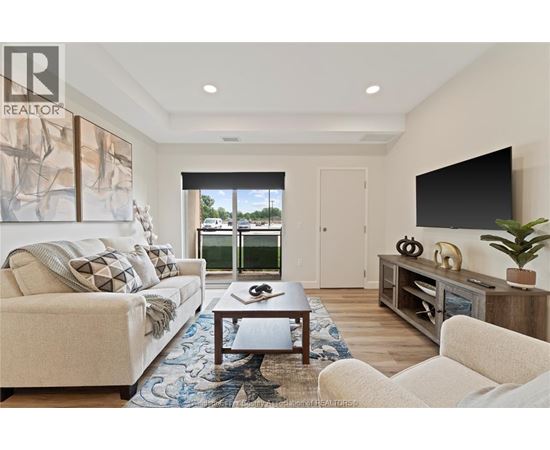 A living room with a couch, a coffee table, and a television.