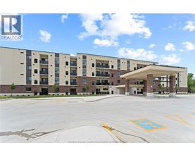 A large building with a parking lot in front of it.