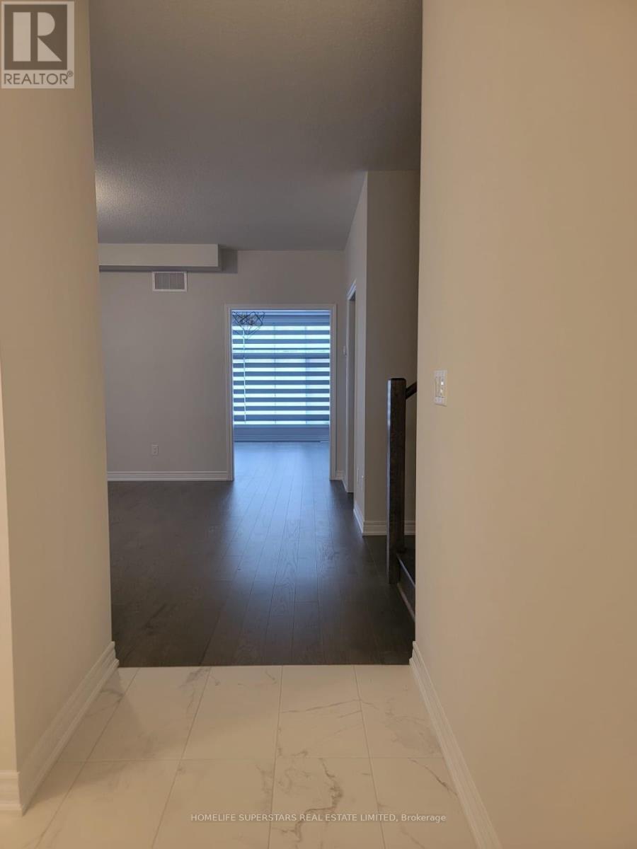 A hallway with a white wall and a window with blinds.