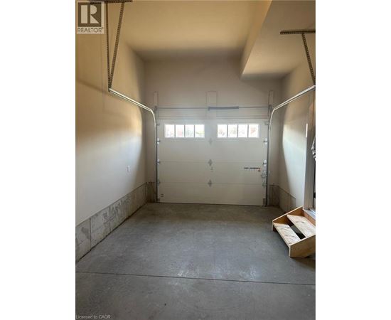 A garage with a white door and windows.