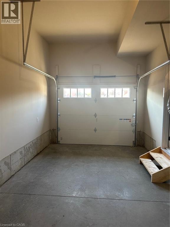A garage with a white door and windows.