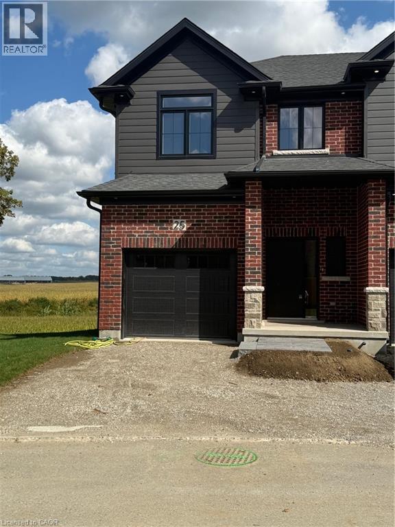 A house with a grey roof and a black garage door.