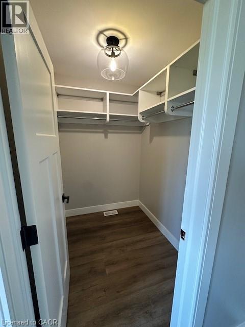 A small bedroom with a bunk bed and a light on.
