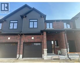 A house under construction with a grey roof and brick walls.