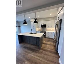 A modern kitchen with a large island and stainless steel appliances.