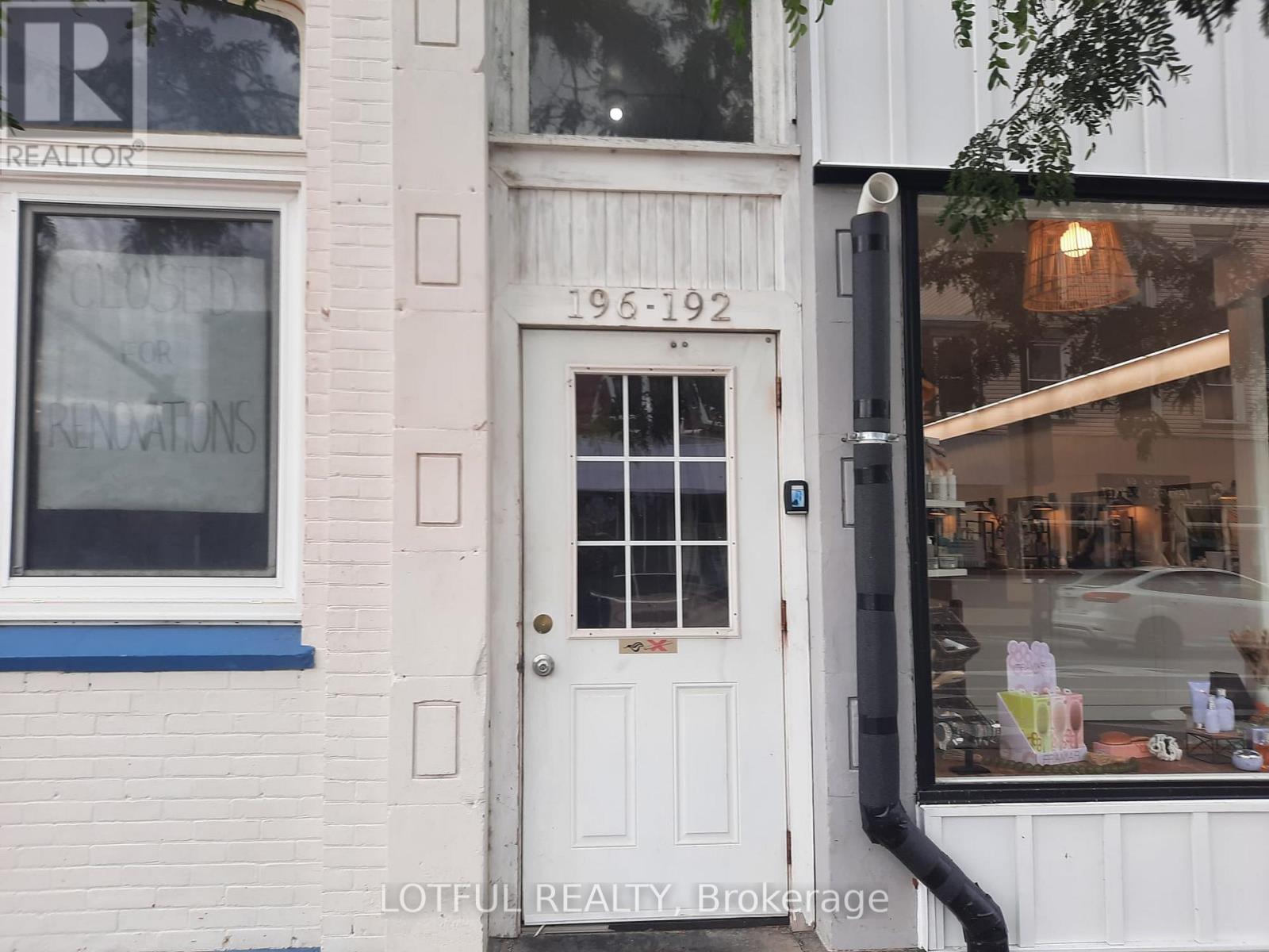 A white door with a glass window and a black handle.