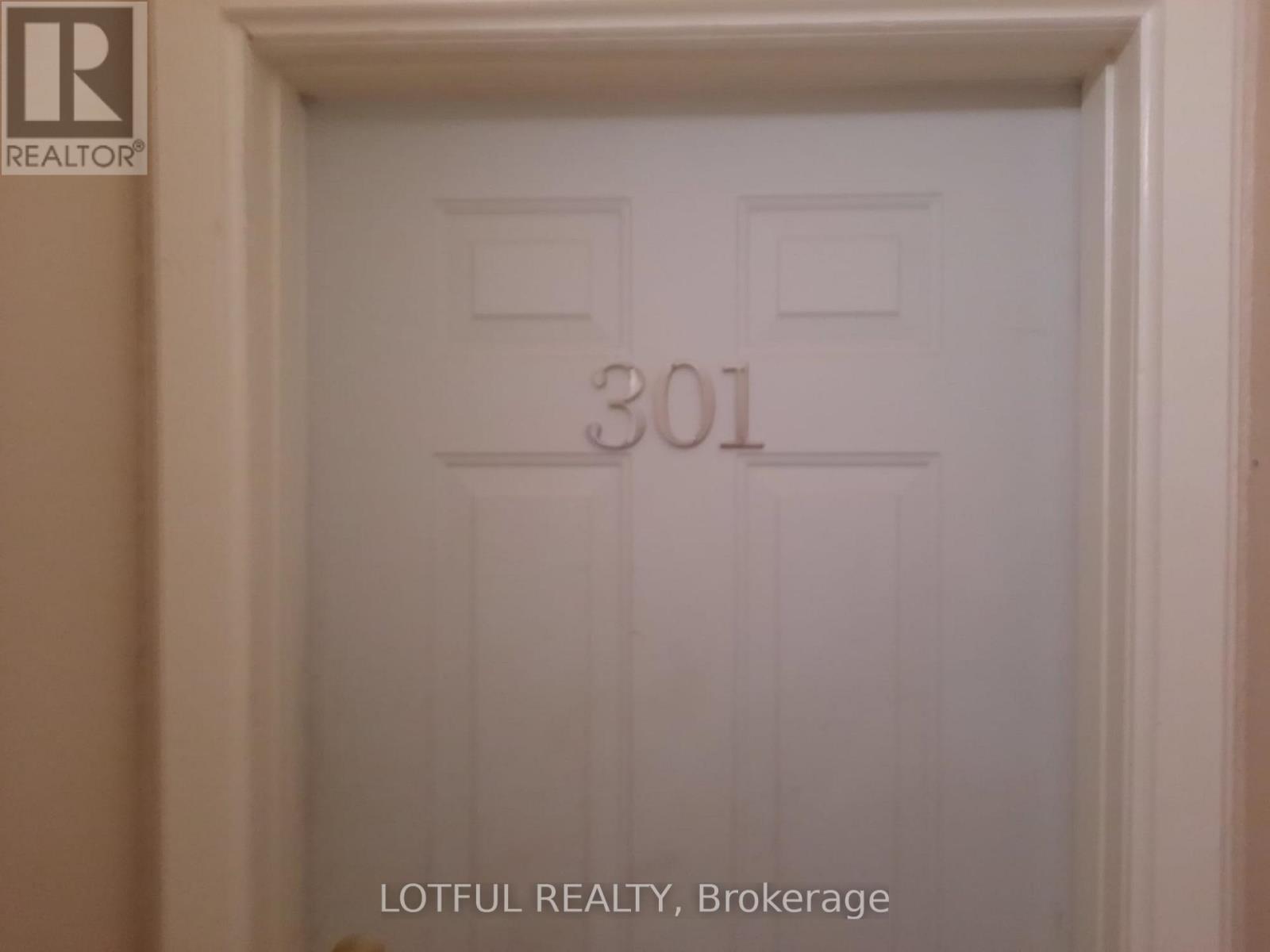 A white door with the number 301 on it.