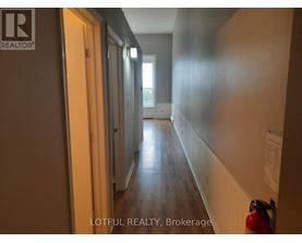 A hallway with a fire extinguisher on the right side.