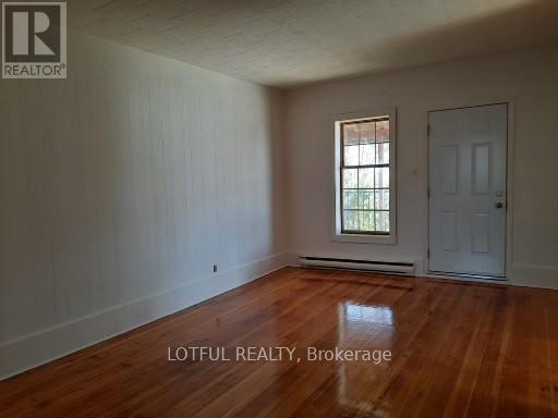 A room with wooden floors and a white door.