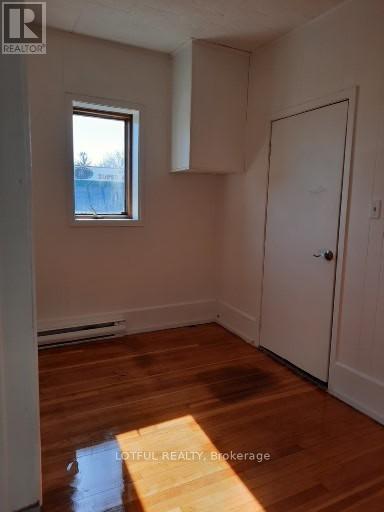 A room with wooden floors and a white door.