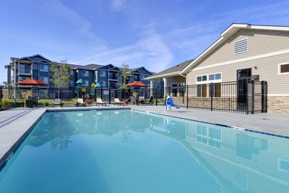 Pool with lounge chairs and apt buildingsCopper Trail Apartments | Apartments in Olympia, WA 