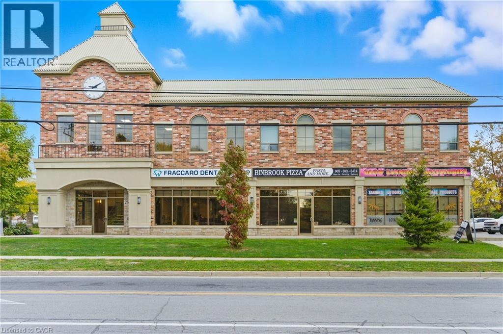 A building with a clock tower and a realtor logo.