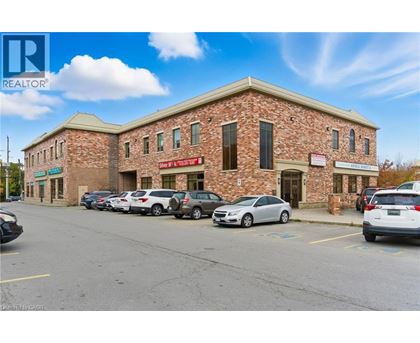 A building with a parking lot in front of it.