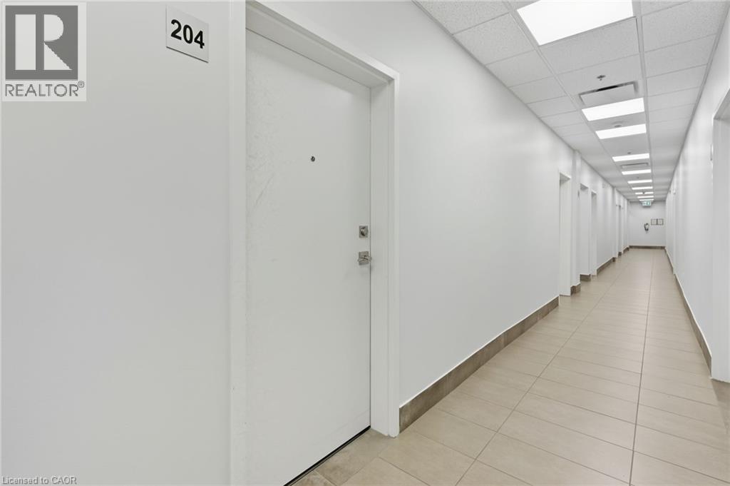 A long hallway with doors on both sides and a sign that says 204.