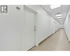A long hallway with doors on both sides and a sign that says 204.