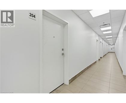 A long hallway with doors on both sides and a sign that says 204.