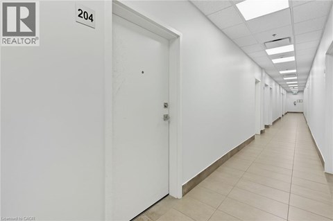 A long hallway with doors on both sides and a sign that says 204.