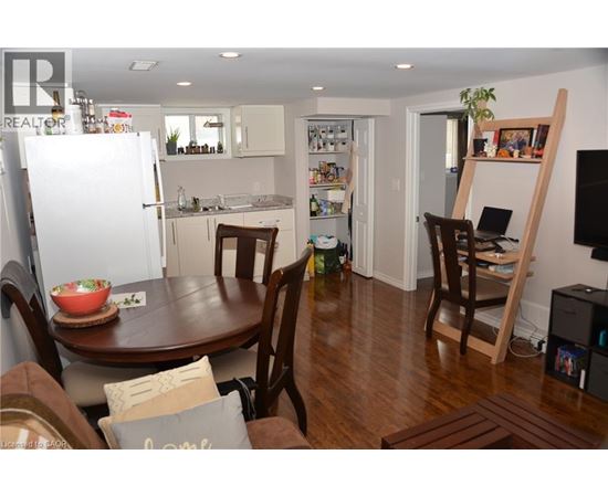A kitchen with a table and chairs in the middle of the room.