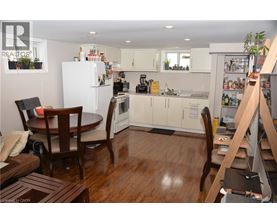 A kitchen with a table and chairs in the middle of the room.