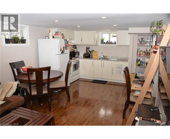 A kitchen with a table and chairs in the middle of the room.