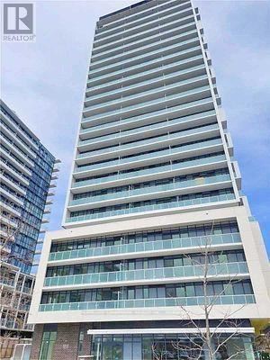 A tall building with many windows is under construction.