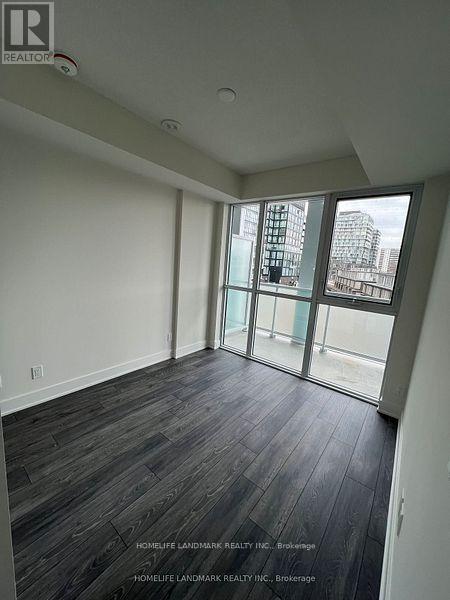 A room with a view of a cityscape through large windows.