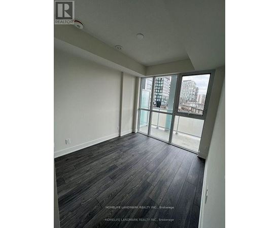 A room with a view of a cityscape through large windows.