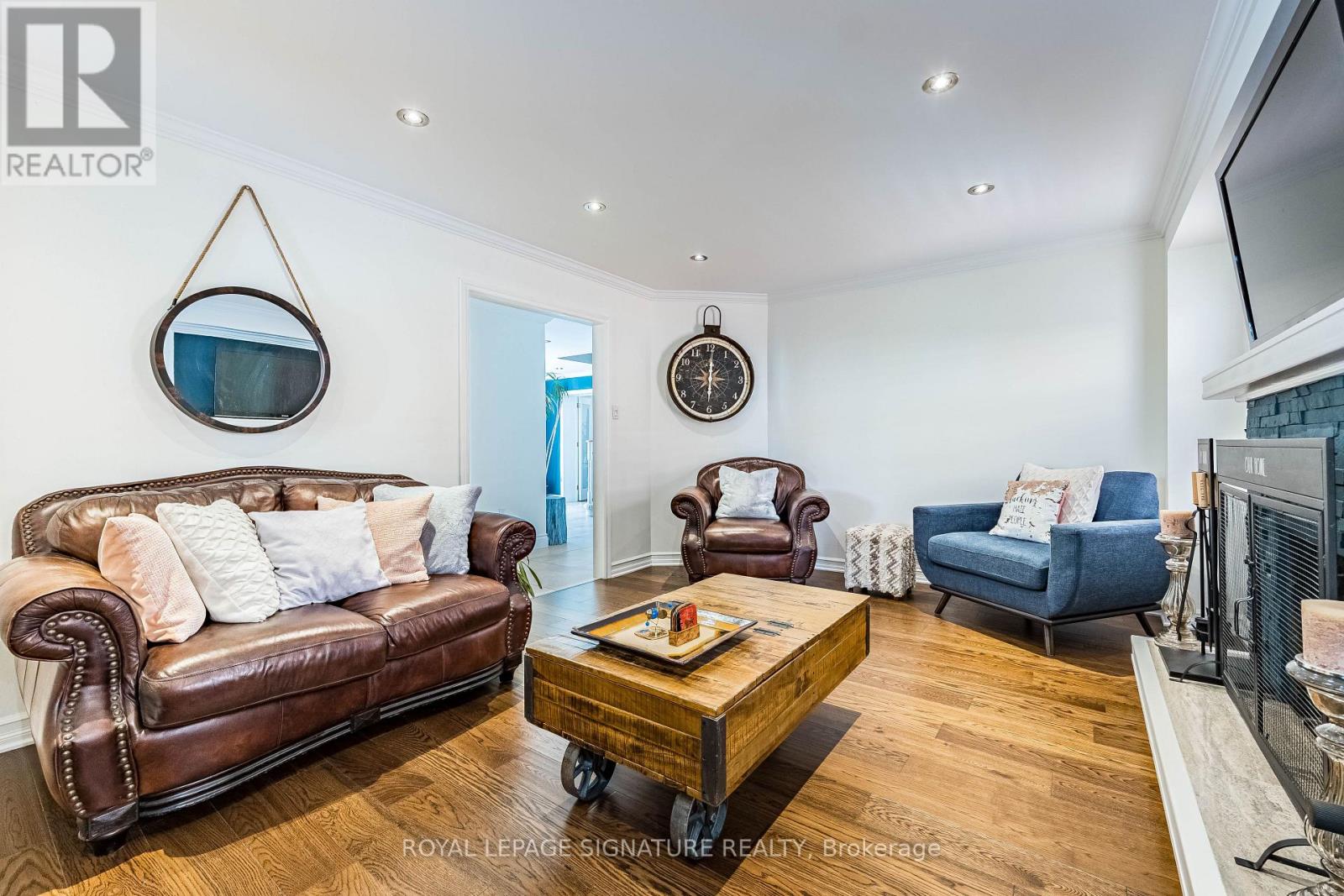 A living room with a brown leather couch and a wooden coffee table.