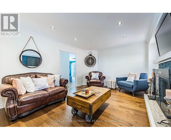 A living room with a brown leather couch and a wooden coffee table.