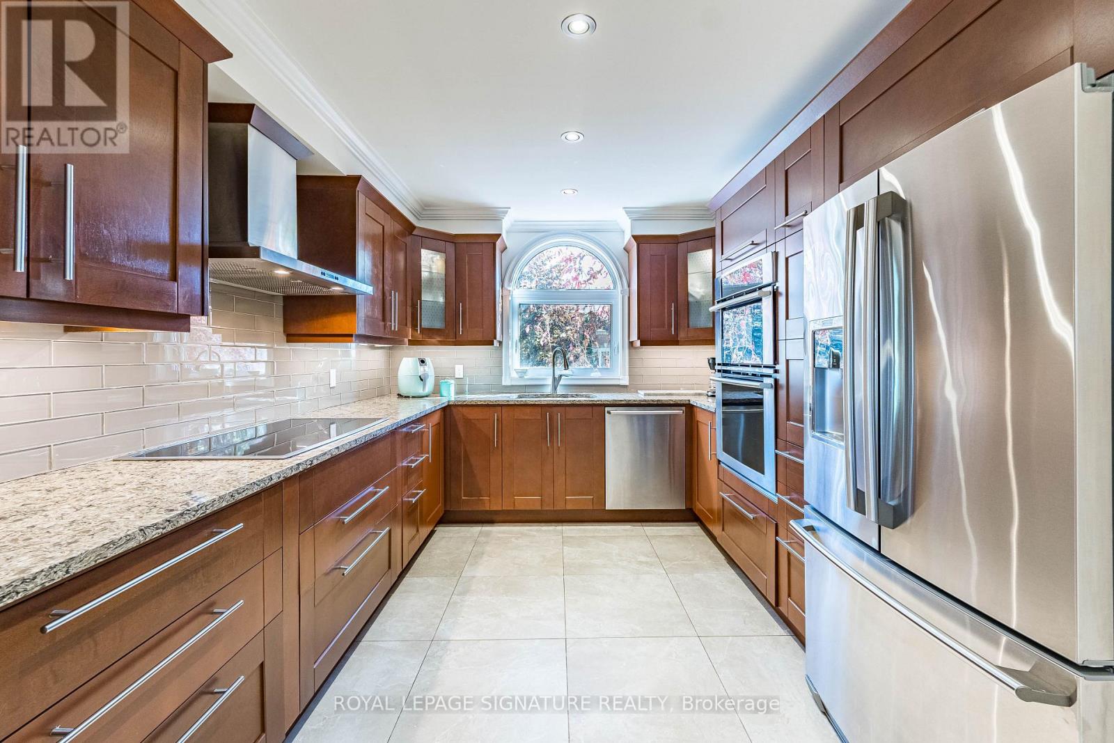 A kitchen with wooden cabinets and stainless steel appliances.