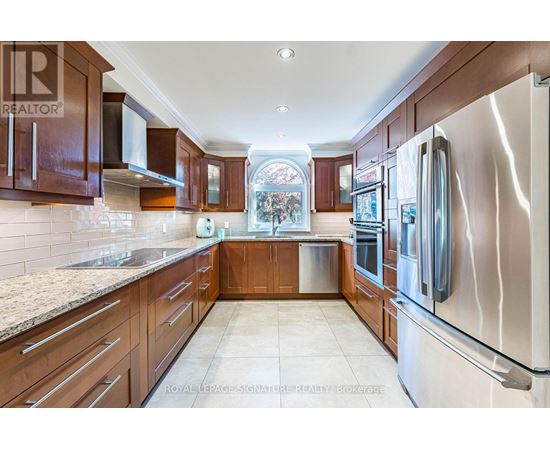 A kitchen with wooden cabinets and stainless steel appliances.
