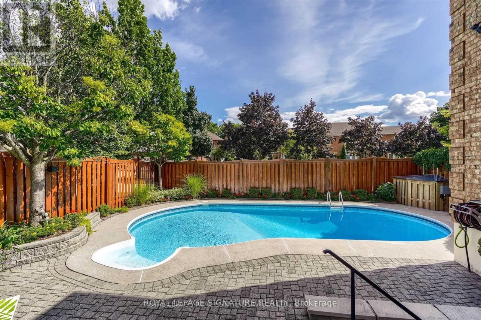 A small kidney-shaped pool surrounded by a brick border.