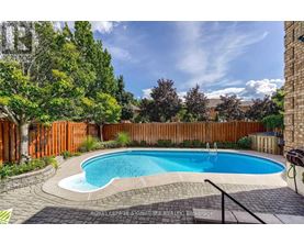 A small kidney-shaped pool surrounded by a brick border.