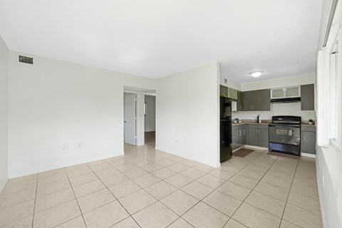 A kitchen with a black oven and white walls.