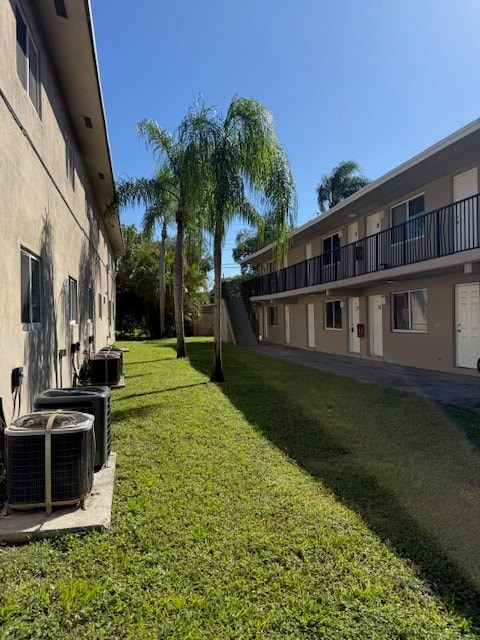 A sunny day at the apartment complex with palm trees and well-kept lawns.