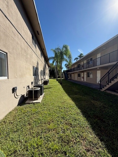 A sunny day at a residential area with apartment buildings and green lawns.