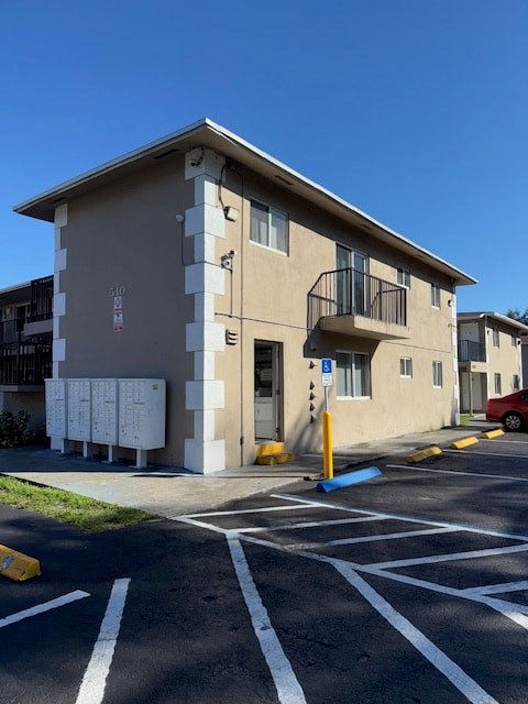 A building with a parking lot in front of it.